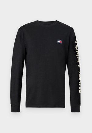 Fekete, hosszú ujjú pamut póló, kis színes logóval a mellkason, és "TOMMY JEANS" felirattal bézs színben az ujján.