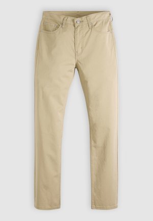 Μπεζ βαμβακερά chinos με σχέδιο ίσιου ποδιού. Διαθέτουν πέντε τσέπες και κλείσιμο με κουμπί. Λεία υφή, με ελάχιστες ραφές.