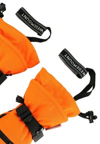 Orange life jacket with adjustable black straps, featuring a smooth texture and buckles. Notable brand tag is visible on the strap.
