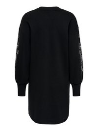 Zwarte sweatjurk met lange mouwen, geribbelde manchetten en witte bloemenborduursels langs beide mouwen, gezien van de achterkant.