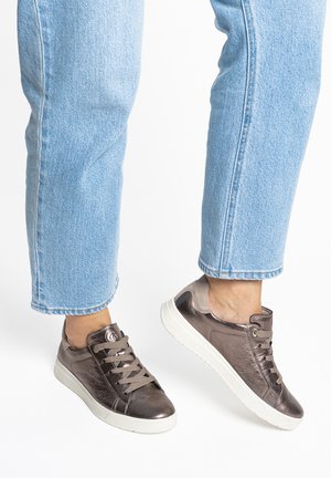 Bronze metallic sneaker with textured upper, round toe, and white rubber sole. Features flat laces and circular logo accent on side.