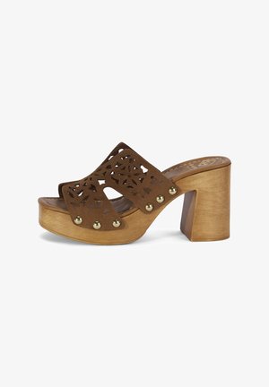 Brauner Wildleder-Open-Toe-Clog mit Holz-Plateauabsatz, floralem Cut-out-Muster und goldenen Nieten an den Seiten.