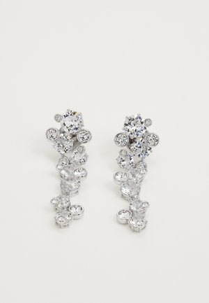 Boucles d'oreilles en argent ornées de cristaux transparents de différentes tailles disposés dans un design en cascade avec des formes circulaires et ovales.