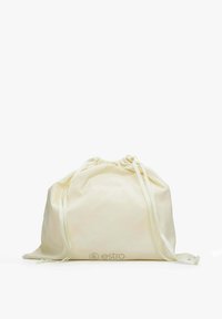 Kremowa torba z płótna ze ściągaczem, z wytłoczonym logo na przodzie i miękką fakturą. Udekorowana pasującymi satynowymi wstążkami.