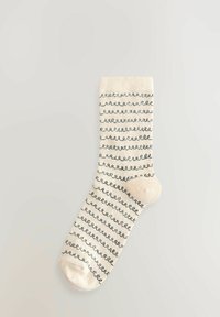 Crème kleurige sok met blauwe golvende strepen, geribbelde bovenkant, gladde textuur en verstevigde teen. Lichtgewicht en flexibele ontwerp.