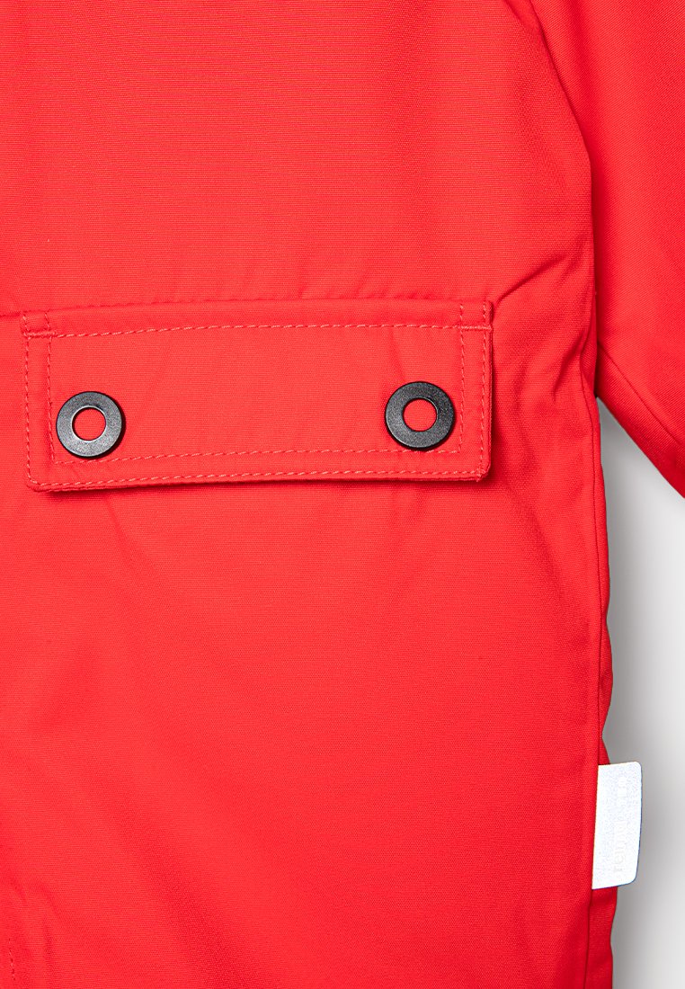 Roter Jackenstoff mit glatter Textur, ausgestattet mit einer Klapptasche, die durch zwei schwarze Druckknöpfe gesichert ist. Beinhaltet ein kleines weißes Etikett an der Seite.