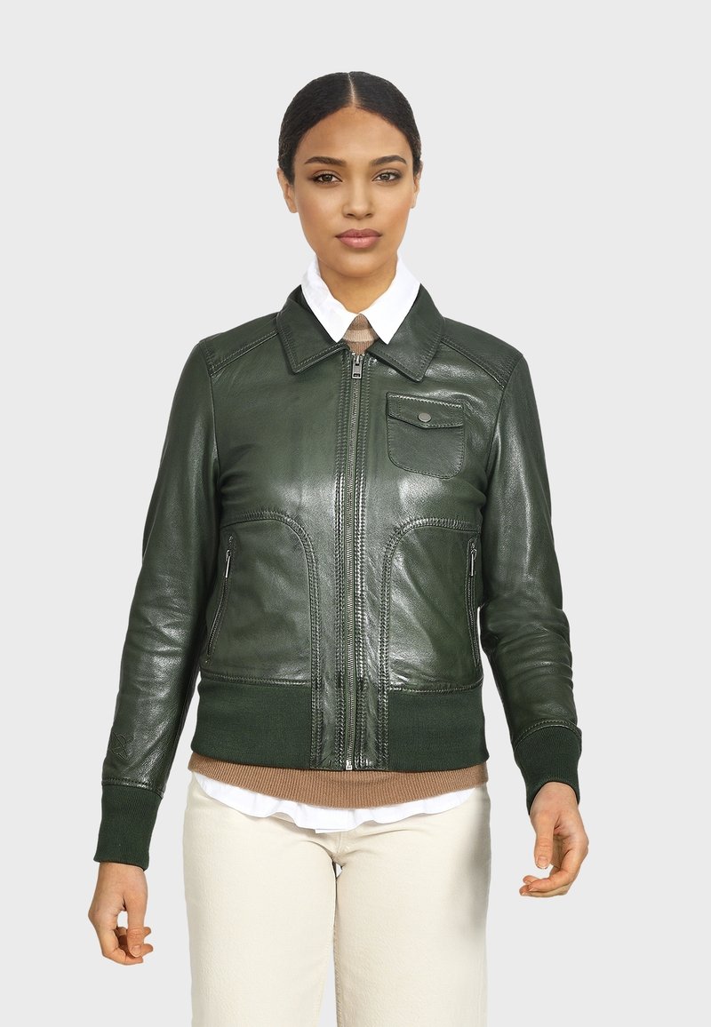 Giacca bomber in pelle verde con zip frontale, polsini e vita a costine, dotata di una tasca sul petto e due tasche laterali con zip.