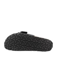 Suola in gomma nera con un motivo ondulato testurizzato, caratterizzata da un design piatto e una fascia in velcro nella parte superiore per una vestibilità sicura.