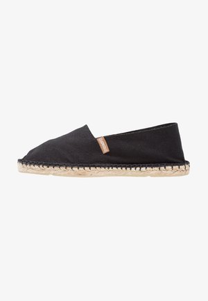 Black canvas espadrille shoe with a rounded toe, jute rope outsole, and a small tan tag on the side. Simple and minimalist design.