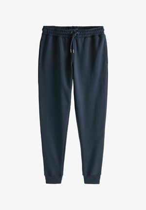 Pantaloni della tuta blu navy realizzati in tessuto morbido, dotati di una vita elastica con cordino, tasche laterali e polsini affusolati.