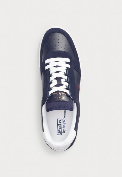 Navy leather sneaker with perforated details, white laces, and a white sole. Features a gold logo accent and soft inner lining.