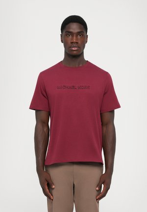 Maroon cotton t-shirt featuring short sleeves and a crew neckline with an embossed "MICHAEL KORS" logo across the chest.