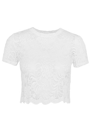 Haut court blanc en dentelle à motif floral, doté de manches courtes et d'un ourlet festonné. Texture lisse et aspect transparent.