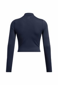 Tumesinine pikkade varrukatega lühike topp, mis on valmistatud kergest ja siledast kangast. Omab tõusvat kaelust ja vormitud disaini, ilma nähtavate logo või mustriteta.