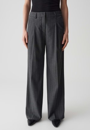 Wide-leg gray trousers made of textured fabric with pinstripe pattern, featuring a fitted waistband and pleated front, paired with black shoes.