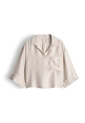 Light beige loose-fit blouse with wide three-quarter sleeves, open collar, and chest pocket, displayed on a white background.