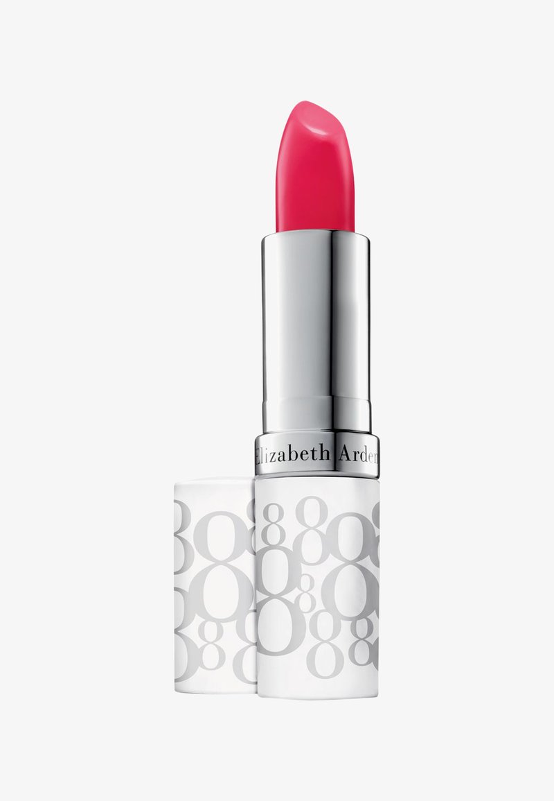 Labial rosa en tubo metálico plateado con packaging blanco y gris que muestra patrones circulares. Textura suave y punta redondeada.