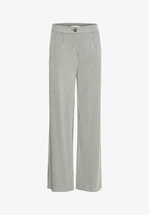 Mustad jaladega püksid musta ja valge kootud mustriga, millel on nööbikinnitus, voldid ja küljetaskud. Valmistatud kergest kangast.