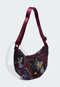 Purple fabric bag with butterfly pattern, curved shape, and glossy maroon strap. Features a black logo patch and zip closure.