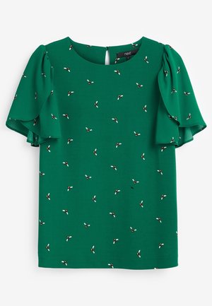 Grüne Bluse mit kurzen, gerafften Ärmeln und kleinen verstreuten Bienenmotiven, mit rundem Ausschnitt und Knopfverschluss am Rücken.