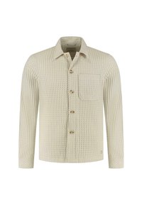 Camicia button-up color crema con un motivo a waffle testurizzato, taschino sul petto singolo e bottoni dorati. Maniche lunghe con polsini abbottonati.