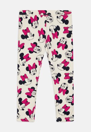 Leggins od mekanog materijala s krem pozadinom i ponavljajućim uzorkom crno-ružičastih lica Minnie Mouse s mašnicama.