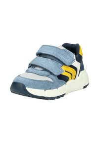 Children's sneaker with blue suede straps, white mesh, yellow accents, and thick white sole, shown from a front side angle.