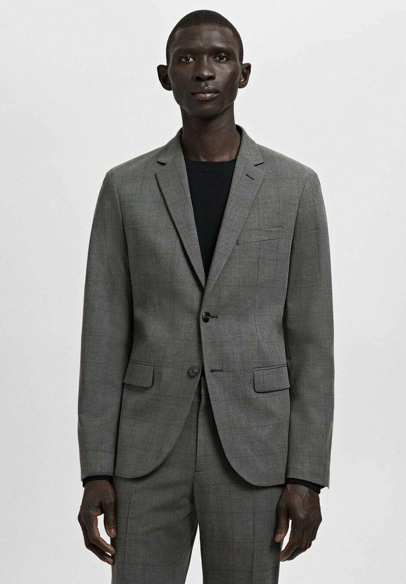 Grauer karierten Blazer mit Kerbklappen, zwei Pattentaschen und einem einzelnen Knopfverschluss, kombiniert mit einem schwarzen Rundhalshemd.