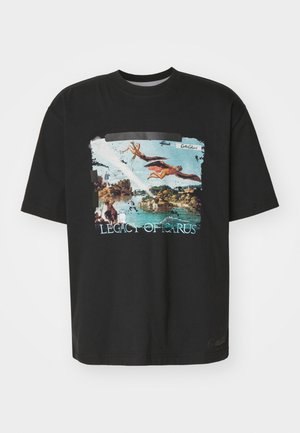 Black cotton T-shirt featuring a vibrant printed design of Icarus with a blue sky and landscape, text reads "LEGACY OF ICARUS."