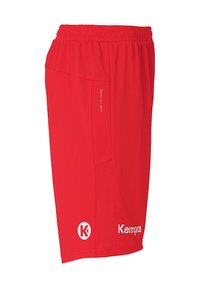 Red athletic shorts made of lightweight fabric, featuring mesh paneling, an elastic waistband, and white logos on the hem and side.