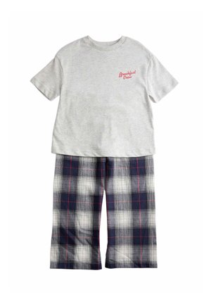 T-shirt grigio chiaro a maniche corte con scritta "Breakfast Crew" in rosso abbinata a pantaloni larghi a quadri blu navy e bianco.