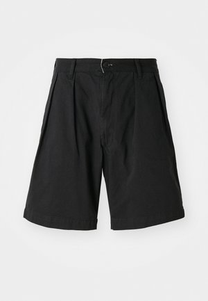 Črne bombažne kratke hlače z gumbnim zapiranjem, plisiranim sprednjim delom in zavihkom na hlačnicah. Preprost dizajn z gladko, mat teksturo.