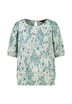 Blouse ample à manches courtes avec motif géométrique et abstrait bleu et blanc, encolure ronde et petite fermeture bouton œillet au dos.