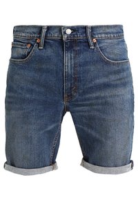 Tummansiniset denim-shortsit, joissa on käänteinen helma, viisi taskua ja kupariset yksityiskohdat. Pehmeä pinta ja klassinen leikkaus.