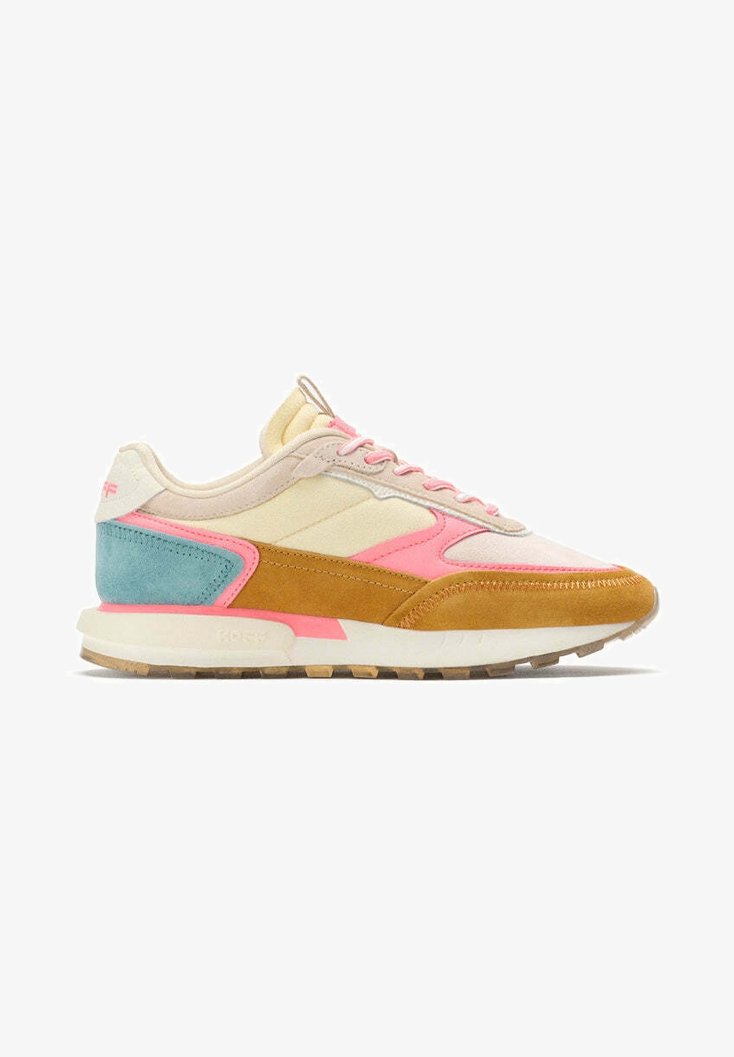 Sneaker featuring a mix of materials: cream fabric, brown suede, turquoise and pink accents. Lightweight sole with textured tread.