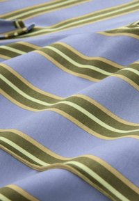 Light blue fabric with olive green, beige, and light green horizontal stripes, showing folds and texture in close-up view.