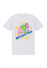 Vit bomullströja med färgglada tecknade björnar, texten "Vi klarar det här" och stjärngrafik i rosa, grönt och lila.