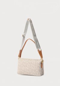 Bež Valentino torba za rame s ponavljajućim uzorkom logotipa, smeđim kožnim obrubom i podesivim sivim platnenim remenom s Valentino brendingom.