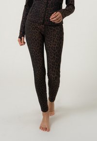 Leggings con stampa leopardata in marrone scuro e nero, realizzati in materiale elasticizzato, caratterizzati da una vestibilità slim e una texture liscia, con vita bassa.