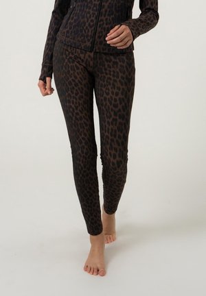 Luipaardprint legging in donkerbruin en zwart, gemaakt van rekbaar materiaal, met een slim fit en een gladde textuur, met een low-rise taille.