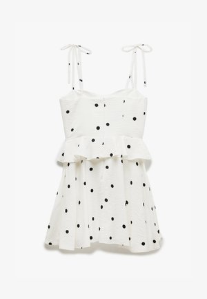 Weißes Kleid mit schwarzen Punkten, mit einem Peplum-Taille, dünnen Schulterbindungen und strukturiertem Stoff. A-Linie Silhouette mit einem ausgestellt Rock.