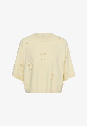 Kremowy sweter z krótkim rękawem, ozdobiony licznymi małymi kokardkami i okrągłym dekoltem.