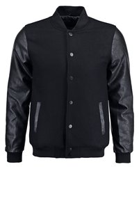 Black bomber jacket with wool body and leather sleeves; features a high collar, snap buttons, and ribbed cuffs. Smooth texture and minimal design.