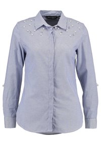 Blue and white striped button-up shirt with pearl embellishments on the shoulders and roll-tab sleeves. Cotton blend fabric, smooth texture.