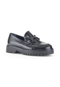 Black glossy loafers with a chunky rubber sole, featuring a decorative buckle accent and stitched detailing along the upper.