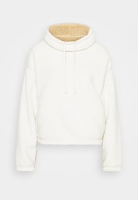 Biała, krótka bluza z kapturem wykonana z pluszowego materiału. Posiada wysoki kołnierz, sznurki oraz miękkie, beżowe wykończenie wewnątrz kołnierza.