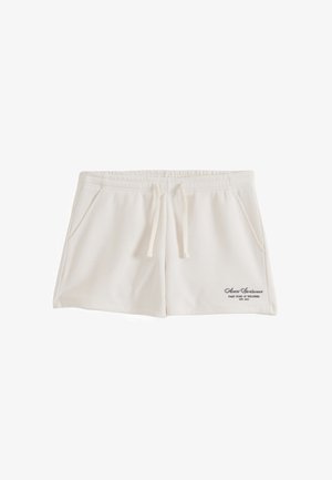 Pantaloncini casual color beige chiaro con vita elastica, coulisse, tasche laterali e piccolo logo con testo nero sulla parte inferiore della gamba sinistra.