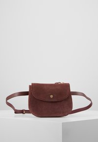 Zamszowa bordowa torebka na ramię z zaokrąglonym klapkiem, złotym zapięciem na zatrzask i dopasowanym regulowanym paskiem. Kompaktowy, prostokątny kształt.