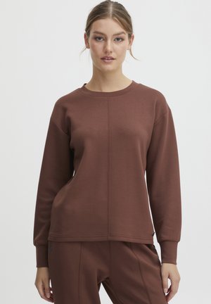 Bruine sweatshirt met lange mouwen, geribbelde manchetten en een ronde hals. Heeft een centrale naaddetail en een gladde textuur. Gekoppeld aan bijpassende broek.
