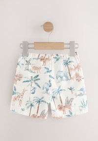 Shorts en coton avec une base blanche et un imprimé coloré d'animaux et de palmiers, dotés d'une ceinture élastique douce et d'une coupe décontractée.